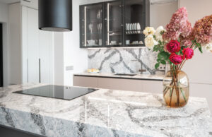 Updated 2000s Southlake TX kitchen with custom stone countertops and warm cabinetry