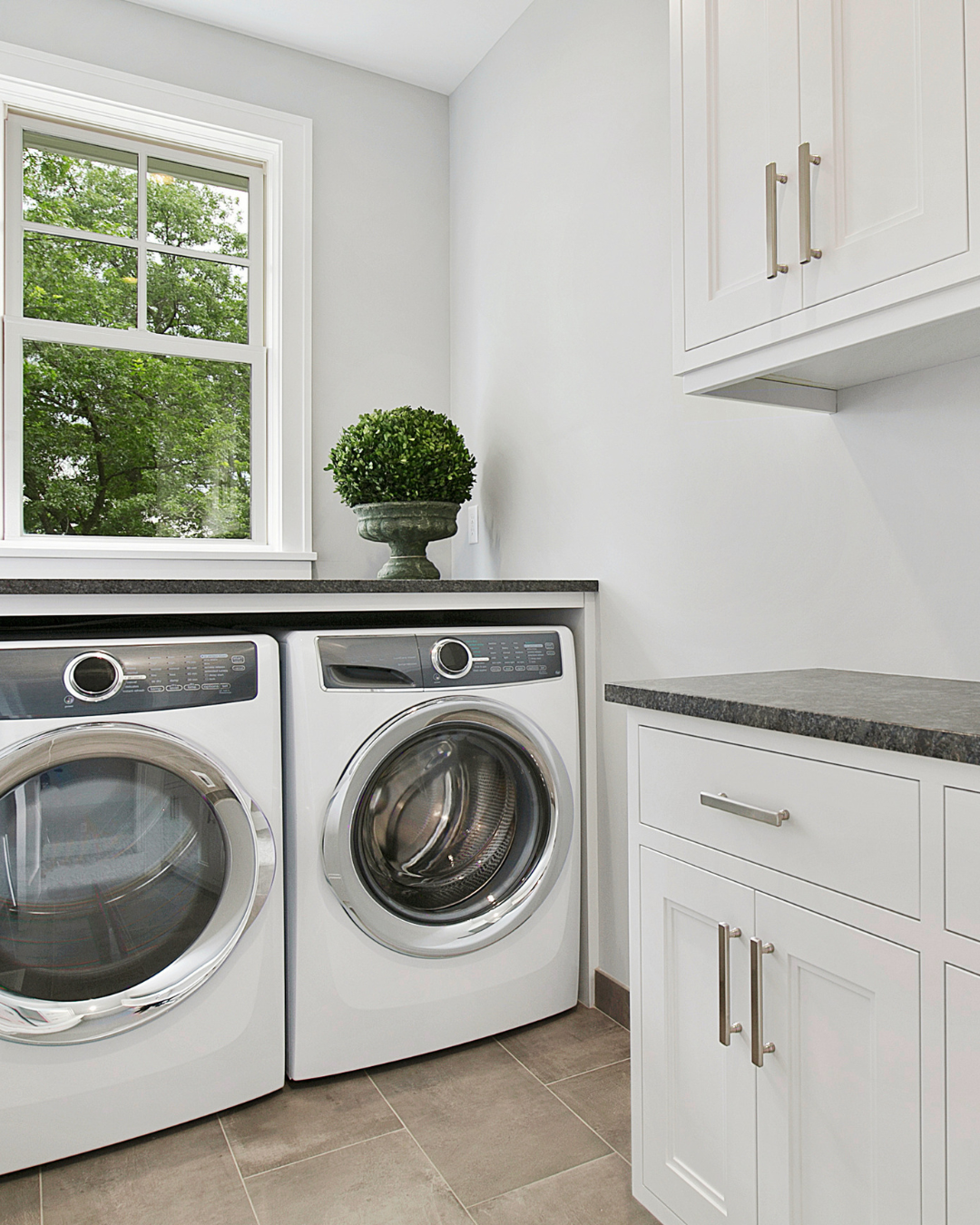 Grapevine laundry room countertops with cabinets and a folding station